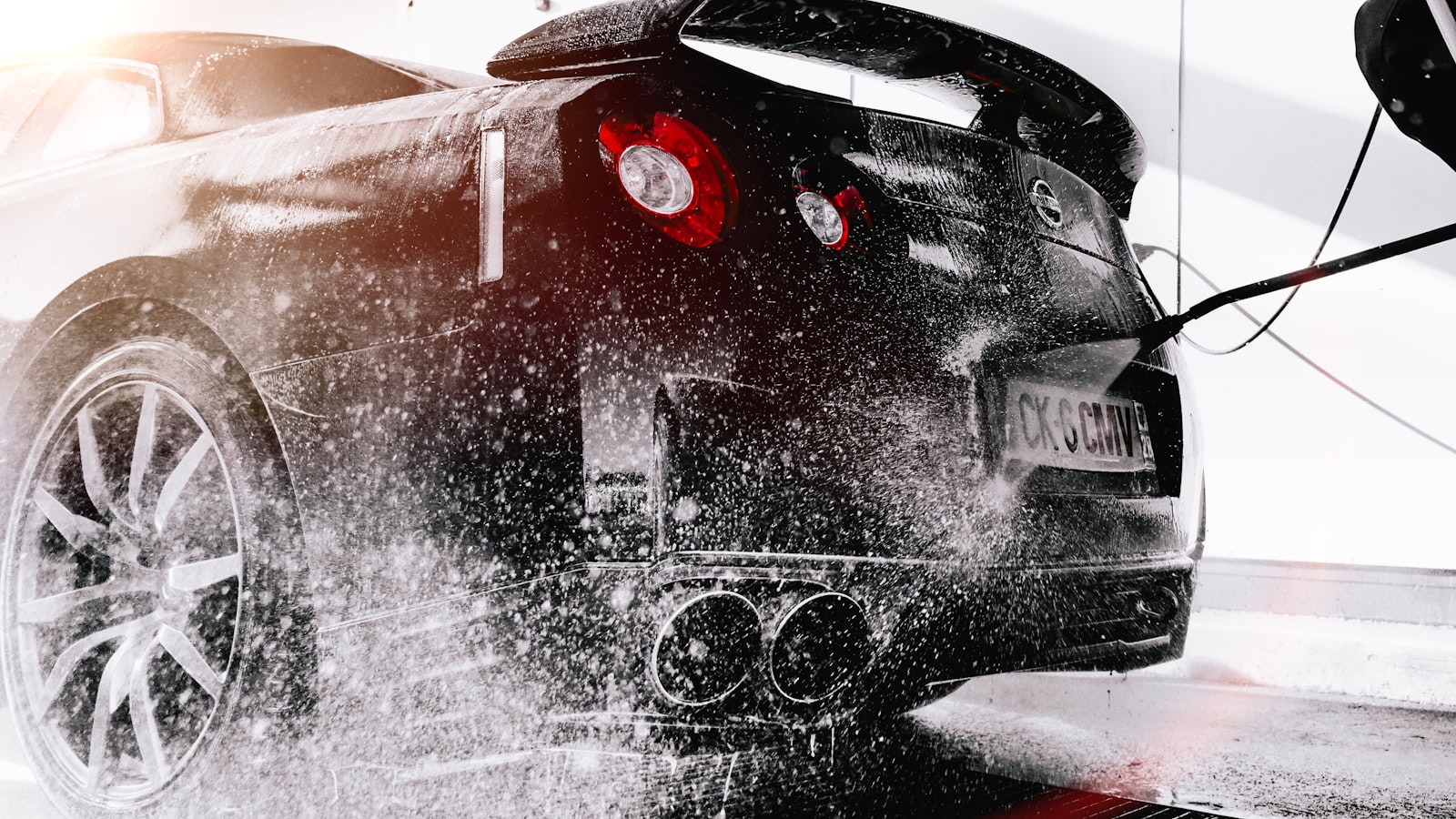 Water beading and sheeting off a ceramic-coated vehicle during a rinse